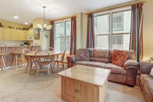 a living room with a couch and a table at Long Trail House - 230 in Stratton