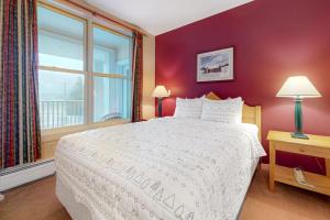a bedroom with a white bed and a window at Long Trail House - 230 in Stratton +36 photos