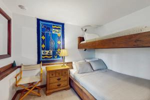 a bedroom with a bunk bed and a desk with a chair at Hawk House in Killington