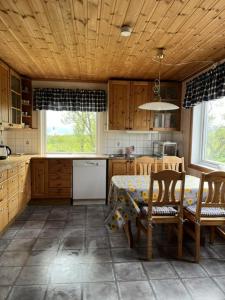a kitchen with a table and chairs and a table and a table and a kitchen at Tenant Farm House in Dverberg