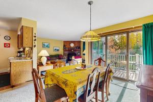a dining room with a table with a yellow table cloth at Kettle Brook A6 in Ludlow