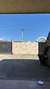 Blick auf ein Gebäude mit einer Backsteinmauer in der Unterkunft Vila Aura in Podgorica