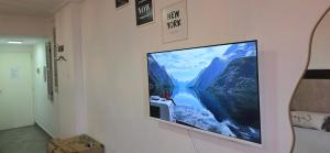 a flat screen tv hanging on a wall at Conesa Suite in General Sarmiento