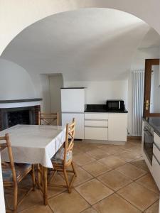 a kitchen with a table and chairs in a room at Casa Chatelain in Ronco sopra Ascona