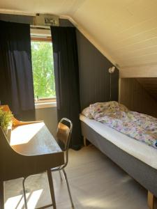 a small bedroom with a bed and a window at Tenant Farm House in Dverberg
