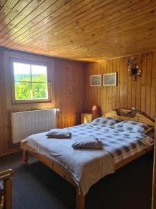a bedroom with a large bed with a wooden ceiling at Andrea Vendégház in Izvoru Mureşului