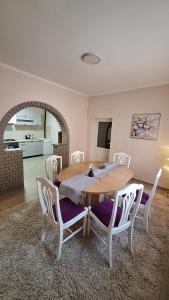 a dining room with a wooden table and chairs at Veslo IN in Krčedin