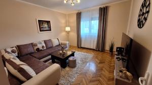 a living room with a couch and a table at Veslo IN in Krčedin