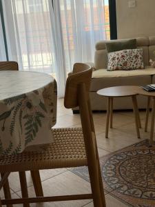 a living room with a table and a couch at Novia Apartment 22 in Đenovići +8 photos