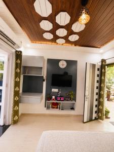 a living room with a television and a ceiling at RK Homes in Delhi