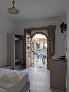 a bedroom with a bed and a view of a patio at Two Brothers Parga in Parga