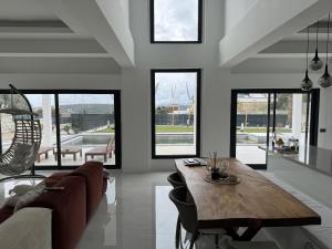a living room with a wooden table and a couch at Luxurious Villa in Cesme with private pool in Çeşme
