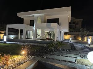 a large white house at night at Luxurious Villa in Cesme with private pool in Çeşme