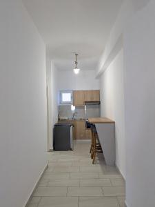 a kitchen with white walls and a counter top at Two Brothers Parga in Parga