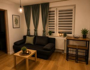 a living room with a couch and a table at Classic Apartment in Konin +3 photos