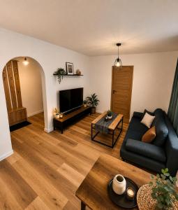 a living room with a couch and a table at Classic Apartment in Konin