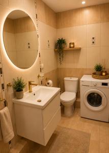 a bathroom with a sink and a washing machine at Classic Apartment in Konin