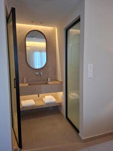 a bathroom with a sink and a mirror at AVRA Apartments & Studios in Frý +86 photos