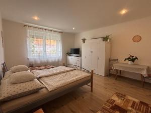a bedroom with a large bed and a table at Prázdninový dom in Štúrovo