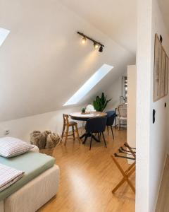 a living room and dining room with a table and chairs at All Homes Apartments Bad Schallerbach in Bad Schallerbach
