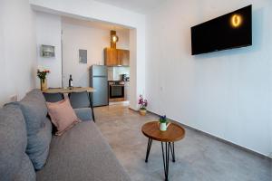 a living room with a couch and a table at Sea U - Apartment in Skala Marion