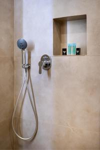 a shower in a bathroom with a shower head at Sea U - Apartment in Skala Marion +25 photos