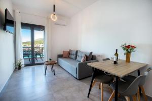 a living room with a couch and a table at Sea U - Apartment in Skala Marion