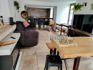 a living room with a couch and a table at Le Grand Stanislas in Nancy