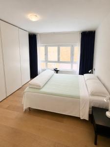 a bedroom with a large bed and a large window at Domus Turrita in Bologna