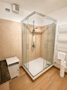 a shower with a glass enclosure in a bathroom at Domus Turrita in Bologna