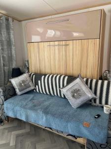 a couch with pillows on it in a room at The Pointon-Bordeaux Caravan Co in Rhyl +35 photos