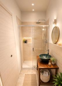 a bathroom with a sink and a shower at Bolsena Cento20 - Rooms & Relax in Bolsena