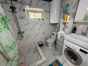 a small bathroom with a toilet and a sink at Nur-Nomad in Balykchy