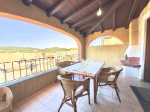 a dining room with a table and chairs on a balcony at Viola House in Villasimius