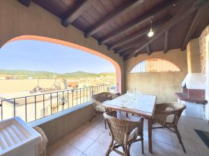 a dining room with a table and chairs on a balcony at Viola House in Villasimius