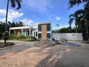 a building with a pile of dirt in front of it at Serenity Banna in Ban Huai Yai