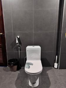 a bathroom with a white toilet in a room at Serenity Banna in Ban Huai Yai