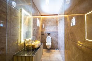 a bathroom with a toilet and a sink at Krish Inn in Chidambaram