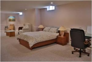 a bedroom with a bed and a desk and a chair at Cozy Family Suite, entire place with two beds, pravite washroom and kitchen in Markham