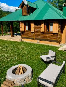 a log cabin with a bench and a fire pit at Holiday house Flores near Kolasin in Kolašin +31 photos