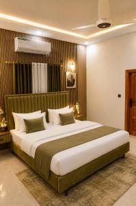 a bedroom with a large bed in a room at City Rooms in Karachi