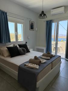 a bedroom with a large bed with towels on it at Princess Sissy in Ios Chora