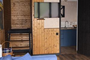 a sliding door with a flat screen tv on top at Mtaura Cabins in Kazbegi