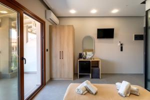 a room with a mirror and a bed with towels at Villa N&D in Ierissos +17 photos