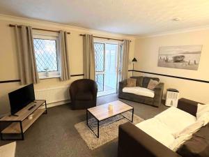 a living room with a couch and a table at Park Cottage in Scunthorpe
