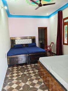 a bedroom with two beds and a ceiling fan at Himalayan due lodge chopta in Sari +14 photos