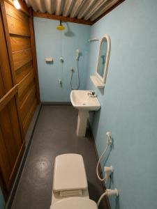 a bathroom with a toilet and a sink at once more hostel in Pottuvil