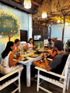 a group of people sitting at a table in a restaurant at once more hostel in Pottuvil