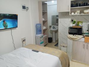 a hospital room with a bed and a tv on the wall at Bliss Apartments in Nakuru