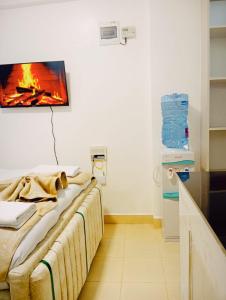 a room with a bed with a fire on the wall at Bliss Apartments in Nakuru